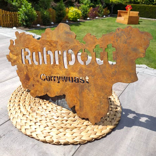 Ein Ruhrpott Umriss in Stahl in der Farbe Rost. Der Umriss beinhaltet das Wort Ruhrpott und Currywuast